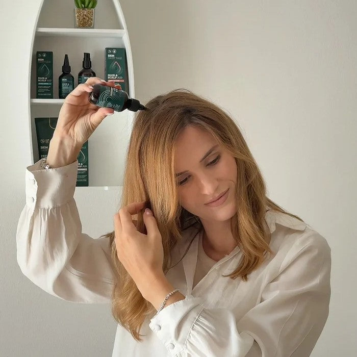 Applying Growth Serum to the scalp from the dropper bottle